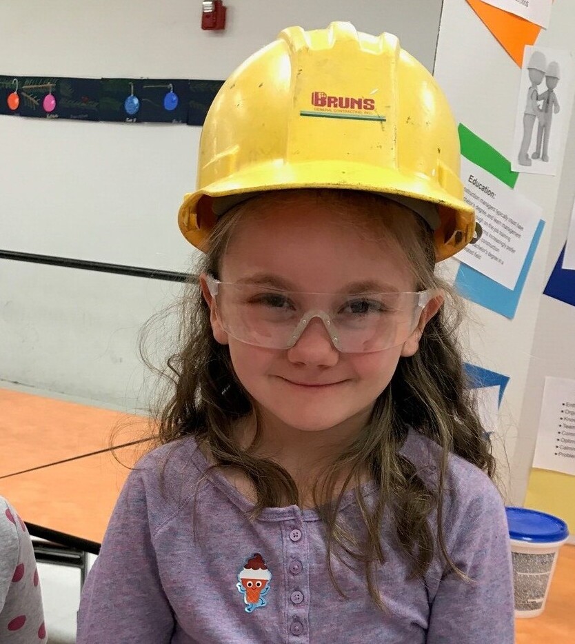 girl wearing a construction hat